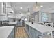 Well-lit kitchen with a large island, stainless steel appliances, and a sleek backsplash design at 812 Gulf # 3, Indian Rocks Beach, FL 33785