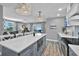 Open-concept kitchen with an island that offers seating, modern appliances and sliding glass doors at 812 Gulf # 3, Indian Rocks Beach, FL 33785