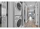 Convenient laundry area with stacked washer and dryer, maximizing space in the hallway at 812 Gulf # 3, Indian Rocks Beach, FL 33785