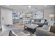 Spacious open-concept living room featuring a kitchen, gray sofas, chairs, and modern decor at 812 Gulf # 3, Indian Rocks Beach, FL 33785