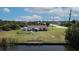 Aerial view of a single-story home with a spacious backyard, patio, and canal access for boaters at 9150 Arrid Cir, Port Charlotte, FL 33981