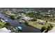 Aerial view of waterfront homes showcasing canals, docks, and lush landscaping in a residential neighborhood at 9150 Arrid Cir, Port Charlotte, FL 33981
