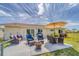 Back patio with outdoor seating, a dining table, and a grill, perfect for entertaining at 9150 Arrid Cir, Port Charlotte, FL 33981