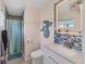 Bright bathroom with modern fixtures, blue backsplash, and a decorative mermaid for added charm at 9150 Arrid Cir, Port Charlotte, FL 33981