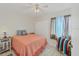 Comfortable bedroom with neutral walls, a cozy bed, and a window with natural light at 9150 Arrid Cir, Port Charlotte, FL 33981