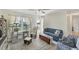 Inviting living room with neutral walls and tile flooring, comfortable seating and a sunlit window at 9150 Arrid Cir, Port Charlotte, FL 33981