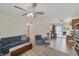 Inviting living room with neutral walls and tile flooring, comfortable seating and a sunlit window at 9150 Arrid Cir, Port Charlotte, FL 33981