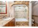 An updated bathroom with a tile arch shower, granite counters, and stylish fixtures at 107 S Obrien St # 117, Tampa, FL 33609