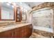 A luxurious bathroom featuring double sinks, granite countertops, and a tiled shower-tub combination at 107 S Obrien St # 117, Tampa, FL 33609