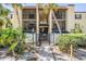 Exterior view of a courtyard in a condo community with mature landscaping at 107 S Obrien St # 117, Tampa, FL 33609