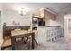 Dining room features a rustic table with breakfast bar area and kitchen in the background at 107 S Obrien St # 117, Tampa, FL 33609