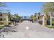 Community entrance showcases tropical landscaping and a clear 
