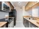 Traditional kitchen featuring stainless steel appliances, tile flooring, and plenty of cabinet storage at 107 S Obrien St # 117, Tampa, FL 33609