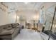 A modern living room featuring a comfortable gray sofa, stylish bar stools, and contemporary decor at 107 S Obrien St # 117, Tampa, FL 33609