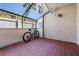 Outdoor patio covered by a pergola with potted plants and bike at 107 S Obrien St # 117, Tampa, FL 33609