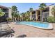Lovely community pool surrounded by lounge seating and lush green landscaping in condo complex at 107 S Obrien St # 117, Tampa, FL 33609