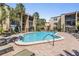 Beautiful community pool with surrounding lounge chairs, tables, and lush tropical landscaping at 107 S Obrien St # 117, Tampa, FL 33609