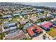 Overhead view of neighborhood with pools, fenced yards, beautiful landscaping, and close proximity to the beach at 108 24Th St, Belleair Beach, FL 33786
