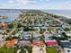 Breathtaking aerial view of a coastal community with lush greenery and beautiful homes near the ocean at 108 24Th St, Belleair Beach, FL 33786