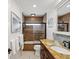 Bright bathroom features a tiled shower/tub, updated vanity with a granite countertop, and decorative mosaic tile backsplash at 108 24Th St, Belleair Beach, FL 33786
