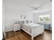 Bright, all white bedroom, featuring wood floors, ceiling fan and window overlooking the yard at 108 24Th St, Belleair Beach, FL 33786