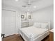 Light and airy bedroom with a queen bed, neutral decor, and natural wood floors at 108 24Th St, Belleair Beach, FL 33786