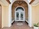 Elegant front entrance featuring double doors with decorative glass and tiled flooring at 108 24Th St, Belleair Beach, FL 33786