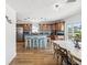Open kitchen with blue island, wood cabinets and stainless steel appliances at 108 24Th St, Belleair Beach, FL 33786
