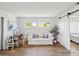 Inviting living room with bright window, comfortable seating, and view into the adjacent bedroom at 108 24Th St, Belleair Beach, FL 33786
