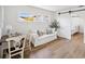 Bright and airy living room with a sliding barn door, a sofa, and a desk at 108 24Th St, Belleair Beach, FL 33786