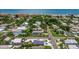 Aerial view showcases a charming neighborhood near the beach, featuring tree-lined streets and cozy homes at 1109 1St St, Indian Rocks Beach, FL 33785