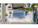 Birds eye view of a home with a gray roof, and crushed shell yard that is located near other homes with backyard pools at 1109 1St St, Indian Rocks Beach, FL 33785