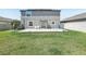 Wide shot of the backyard featuring a lush lawn and a concrete patio for relaxing and entertaining at 11218 Sage Canyon Dr, Riverview, FL 33578