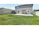 The grassy backyard offers outdoor enjoyment with a sunny patio and room for recreation and relaxation at 11218 Sage Canyon Dr, Riverview, FL 33578