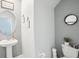Cozy half bathroom with a pedestal sink and neutral grey paint, with a unique framed piece of art at 11218 Sage Canyon Dr, Riverview, FL 33578