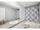 Neutral bathroom featuring large mirror and shower-tub combo at 11218 Sage Canyon Dr, Riverview, FL 33578