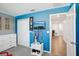 Blue bedroom with ceiling fan, closet, and view of hallway at 11218 Sage Canyon Dr, Riverview, FL 33578