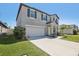 Beautiful home featuring an attached two car garage, manicured lawn, and quaint front entrance at 11218 Sage Canyon Dr, Riverview, FL 33578