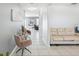Bright hallway with neutral paint leads to the main living areas, furnished with chairs and decorative pieces at 11218 Sage Canyon Dr, Riverview, FL 33578