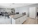 Open-concept kitchen and dining area, featuring a spacious granite island and tile flooring at 11218 Sage Canyon Dr, Riverview, FL 33578