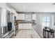 Modern kitchen featuring stainless steel appliances, white cabinets, and granite countertops at 11218 Sage Canyon Dr, Riverview, FL 33578
