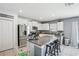 Well-lit kitchen features stainless steel appliances, white cabinets, and a spacious granite island at 11218 Sage Canyon Dr, Riverview, FL 33578