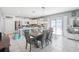 Open-concept kitchen and dining area with modern lighting and a sliding glass door at 11218 Sage Canyon Dr, Riverview, FL 33578