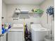 Convenient laundry room with washer, dryer, overhead shelving for easy organization at 11218 Sage Canyon Dr, Riverview, FL 33578