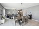 Open-concept living and dining area with tile flooring, modern lighting, and neutral paint at 11218 Sage Canyon Dr, Riverview, FL 33578