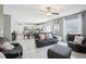 Open-concept living room with tile floors seamlessly flows into the kitchen and dining area at 11218 Sage Canyon Dr, Riverview, FL 33578