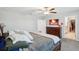 Carpeted main bedroom with a ceiling fan, tv, walk-in closet, and a wooden bed frame at 11218 Sage Canyon Dr, Riverview, FL 33578