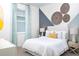 Stylish bedroom featuring cool-toned decor, geometric wall art, and a calming atmosphere at 11795 Starbright Path, Venice, FL 34293