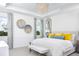 Serene bedroom with a plush bed, stylish decor, large windows, and plenty of natural light at 11795 Starbright Path, Venice, FL 34293
