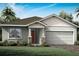 Charming single-story home with a red front door, two-car garage, and well-maintained landscaping at 11795 Starbright Path, Venice, FL 34293